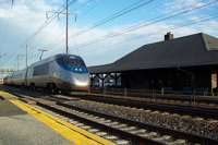 Amtrak Acela train passing a station Amtrak Acela train passing a station